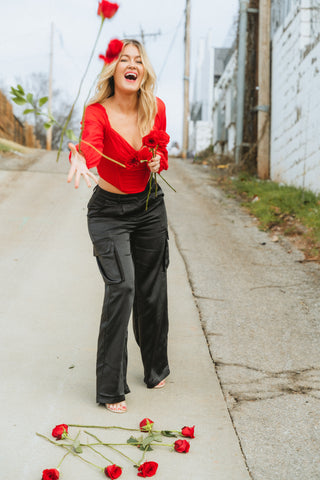 Red corset top paired with black satin cargo pants from generatoarekipor boutique in Poland City